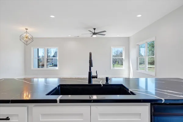 a kitchen with stainless steel appliances granite countertop a sink and a stove