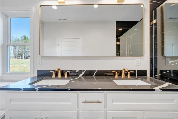 a front view of a house with a garden and yard