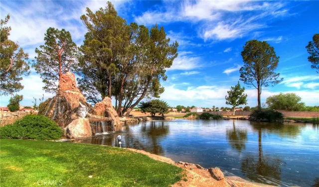 a lake view with boat and trees in the background