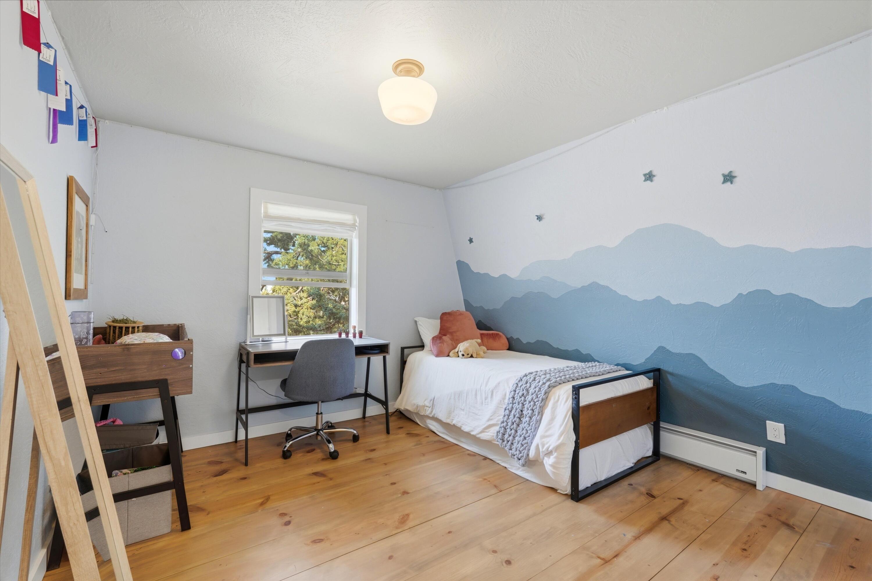 61280 Larsen Road Bend, OR 97702 - Photo 24 of 58 a bedroom with a bed and a window
