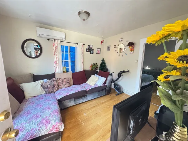 a living room with furniture and wall paintings