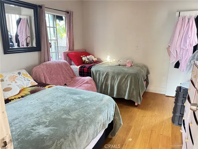 a bedroom with two beds and a painting on the wall