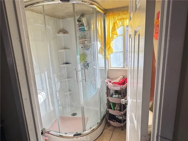 a room with a glass door and shower