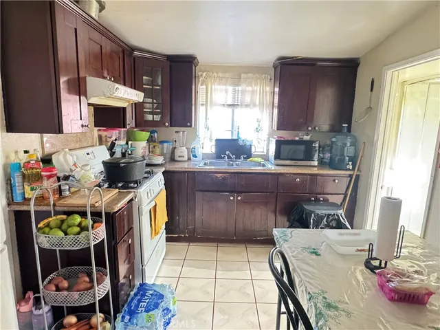 a kitchen with a sink and a stove top oven