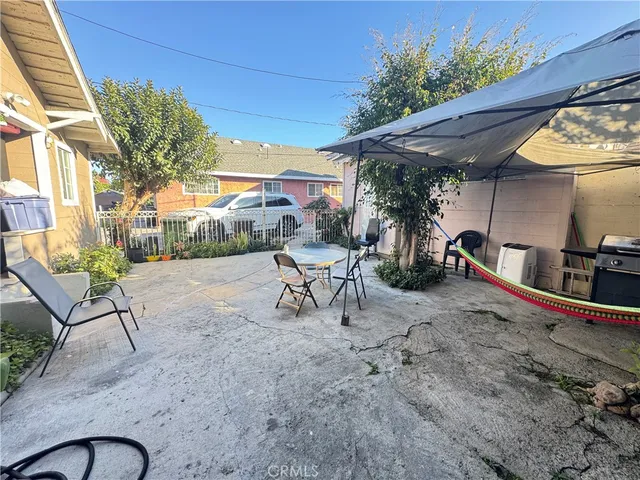 a view of a backyard with a patio and a fire pit
