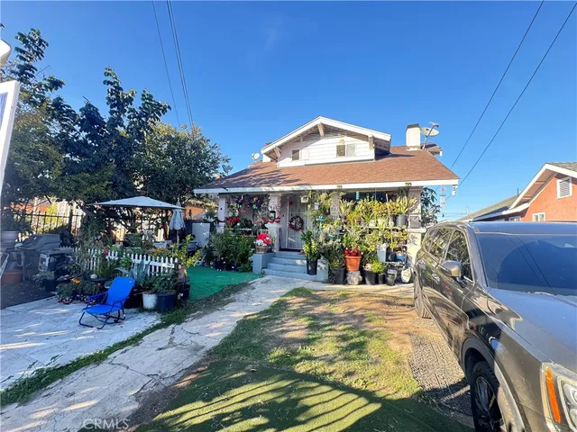 a view of a patio with table and chairs under an umbrella