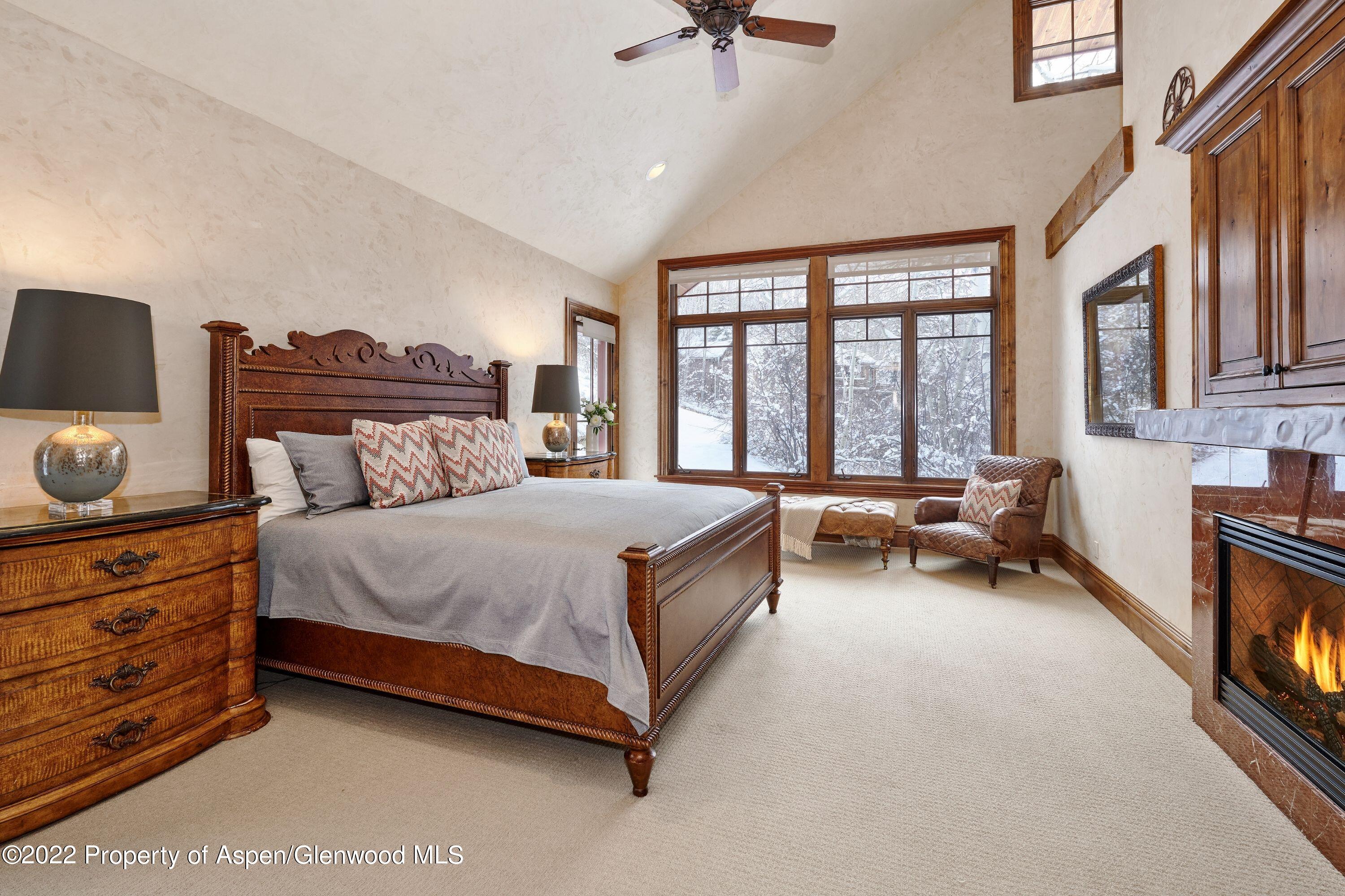 64 Spruce Ridge Lane Snowmass Village, CO 81615 - Photo 11 of 37 a spacious bedroom with a bed and a couch