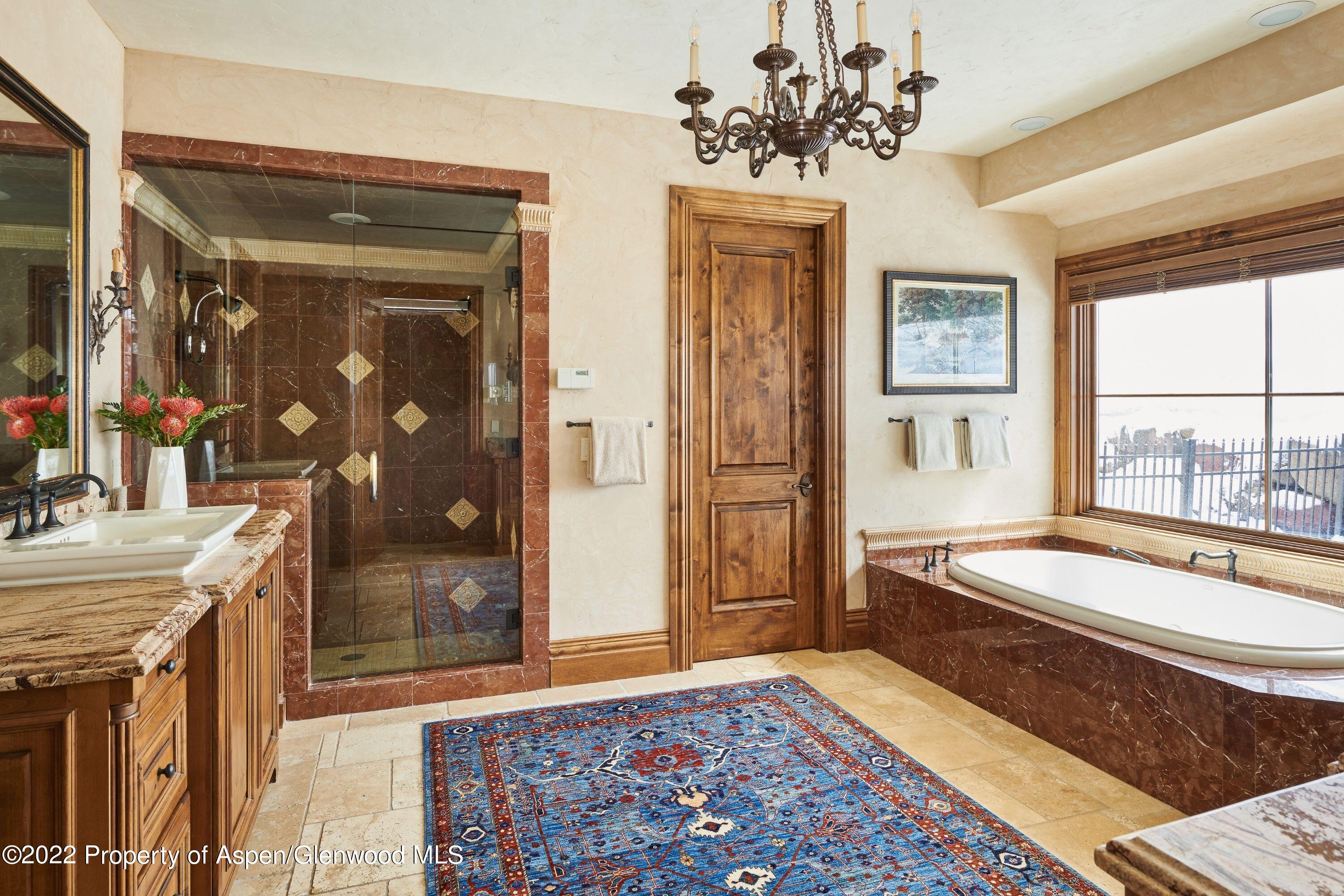 64 Spruce Ridge Lane Snowmass Village, CO 81615 - Photo 12 of 37 a spacious bathroom with a granite countertop tub and a sink