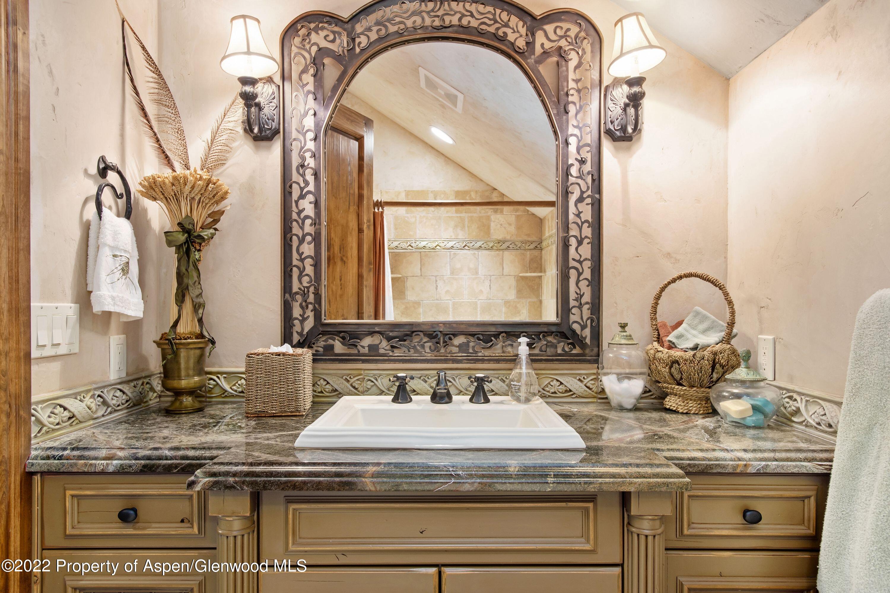 64 Spruce Ridge Lane Snowmass Village, CO 81615 - Photo 16 of 37 a bathroom with a granite countertop sink and a mirror
