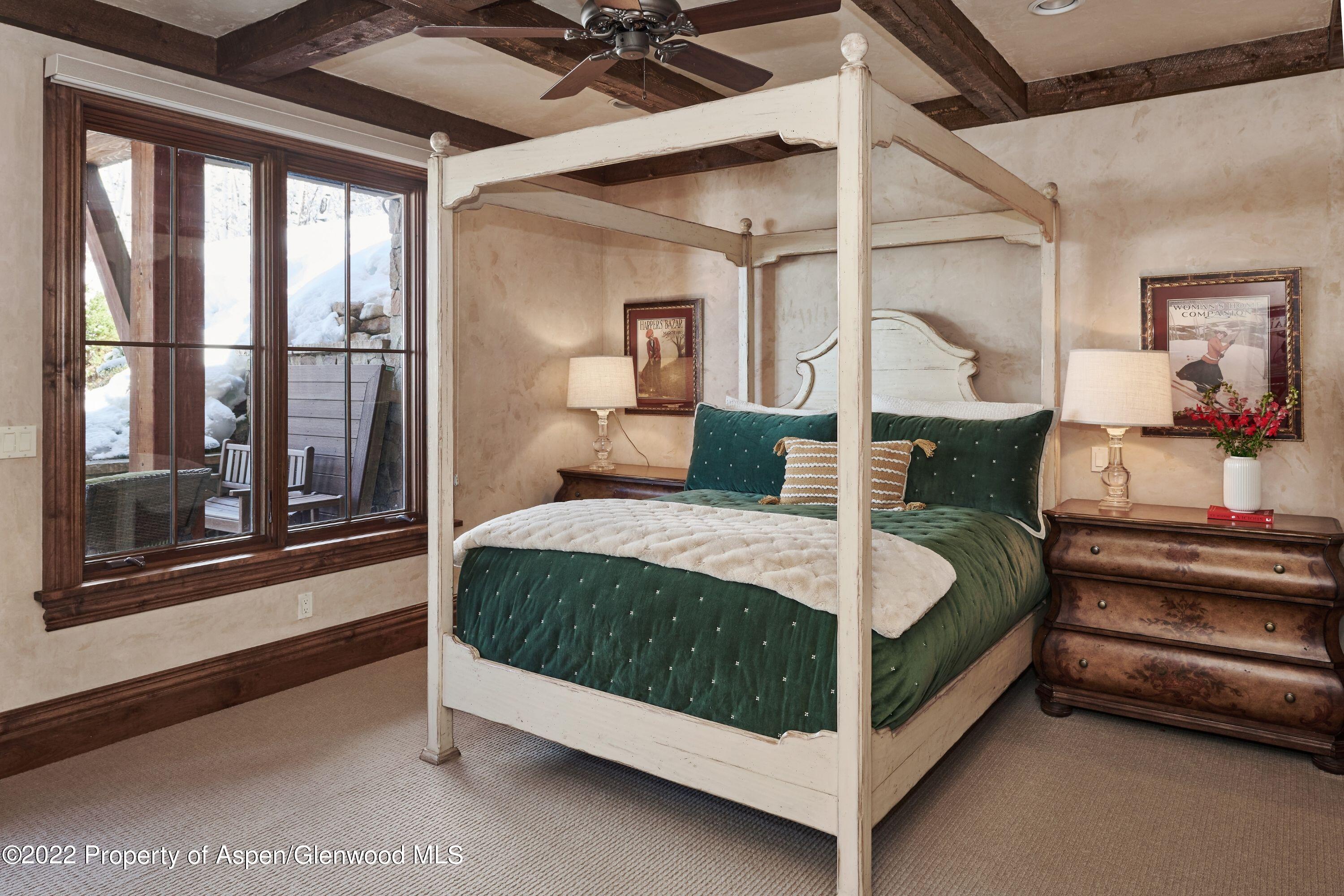 64 Spruce Ridge Lane Snowmass Village, CO 81615 - Photo 18 of 37 a bedroom with a bed lamp and window