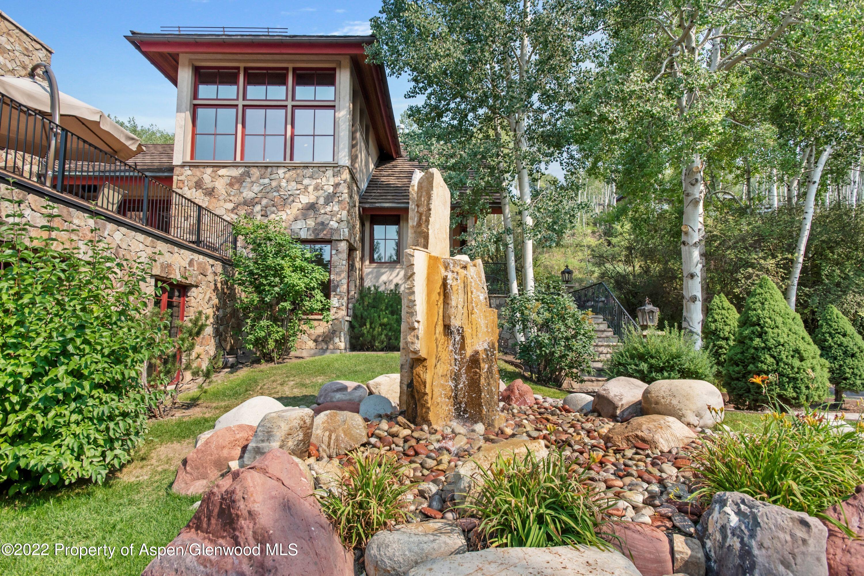 64 Spruce Ridge Lane Snowmass Village, CO 81615 - Photo 30 of 37 a front view of a house with a yard