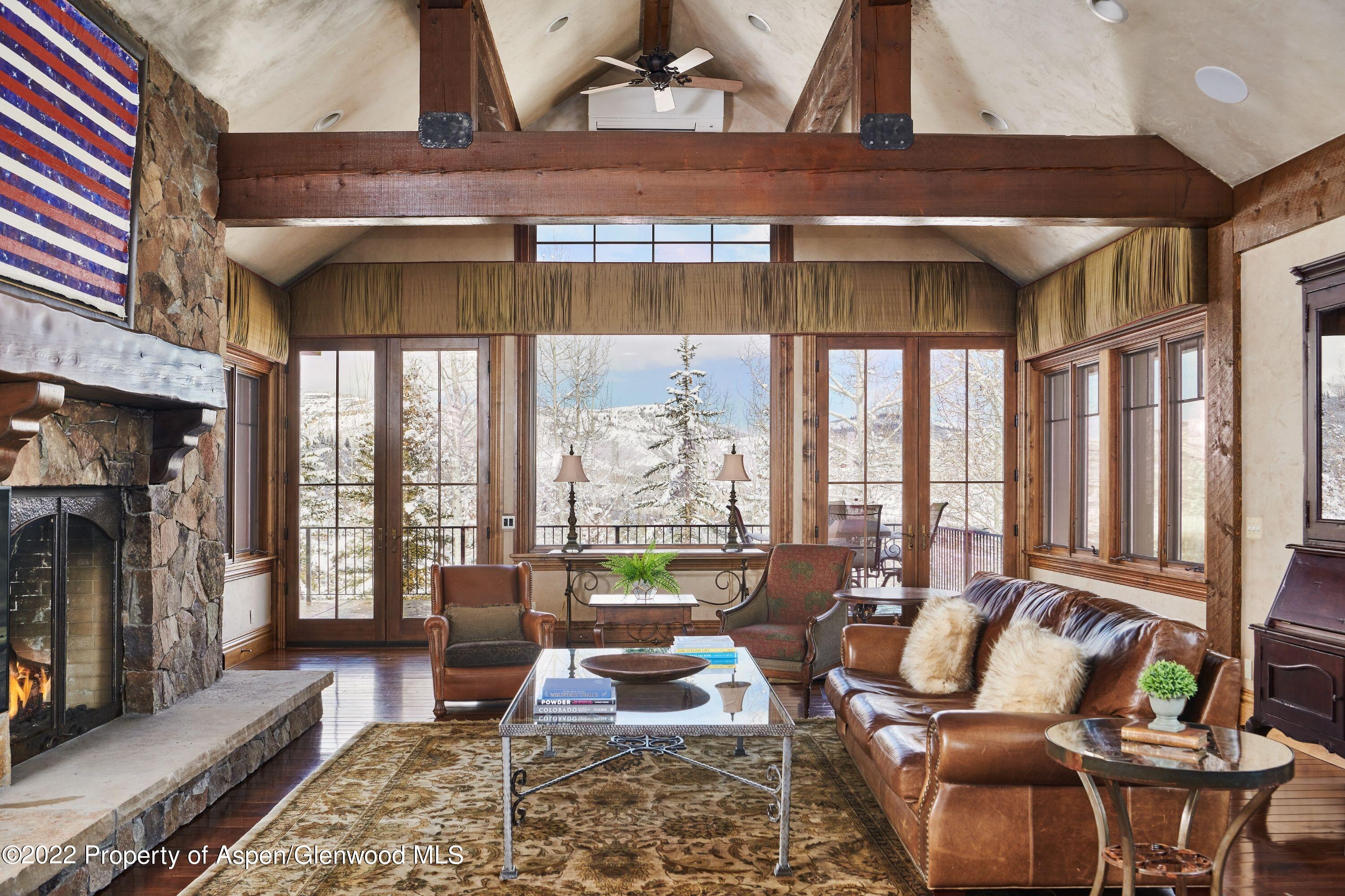 64 Spruce Ridge Lane Snowmass Village, CO 81615 - Photo 3 of 37 a living room with furniture and a floor to ceiling window