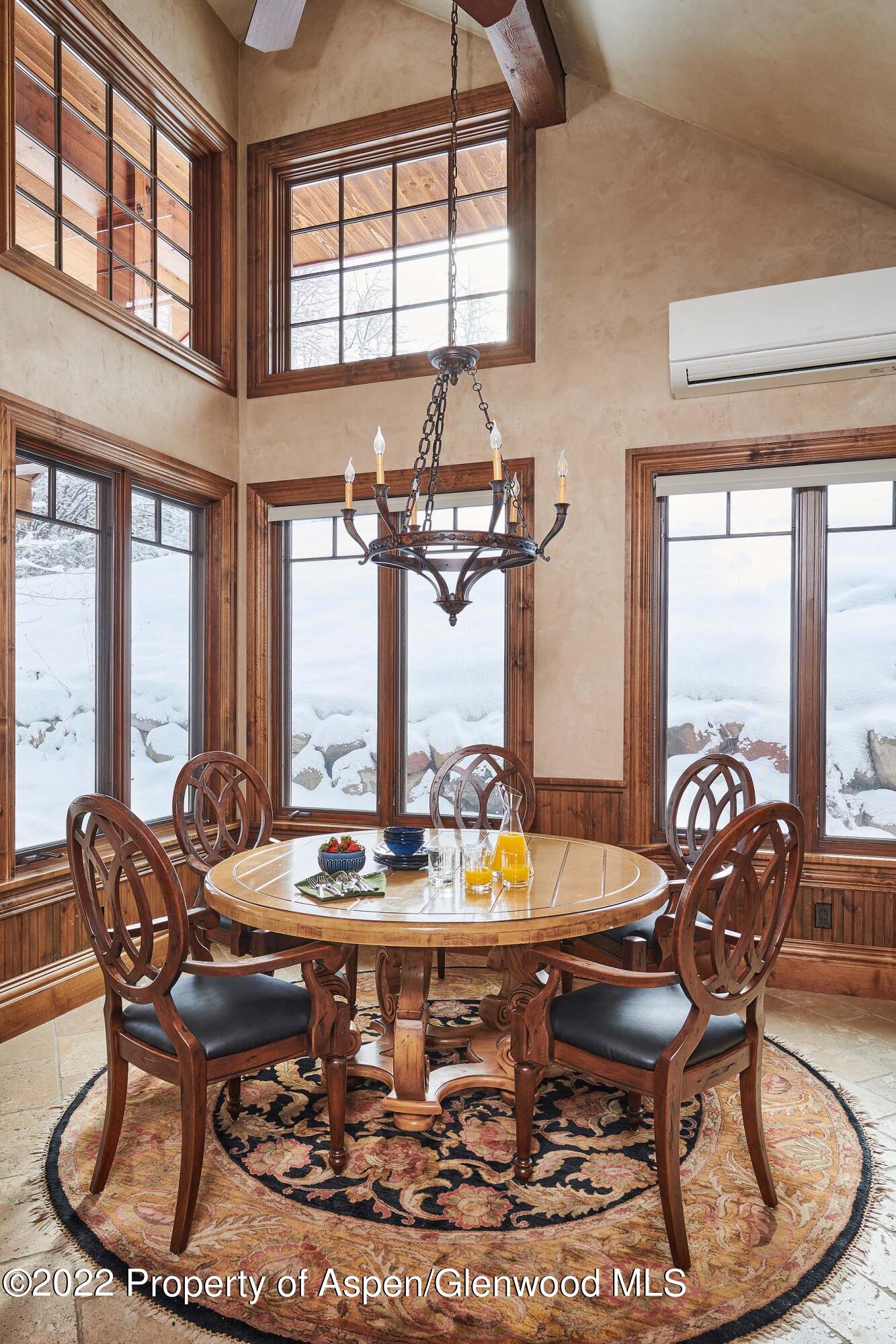 64 Spruce Ridge Lane Snowmass Village, CO 81615 - Photo 7 of 37 a dining room with furniture a chandelier and wooden floor