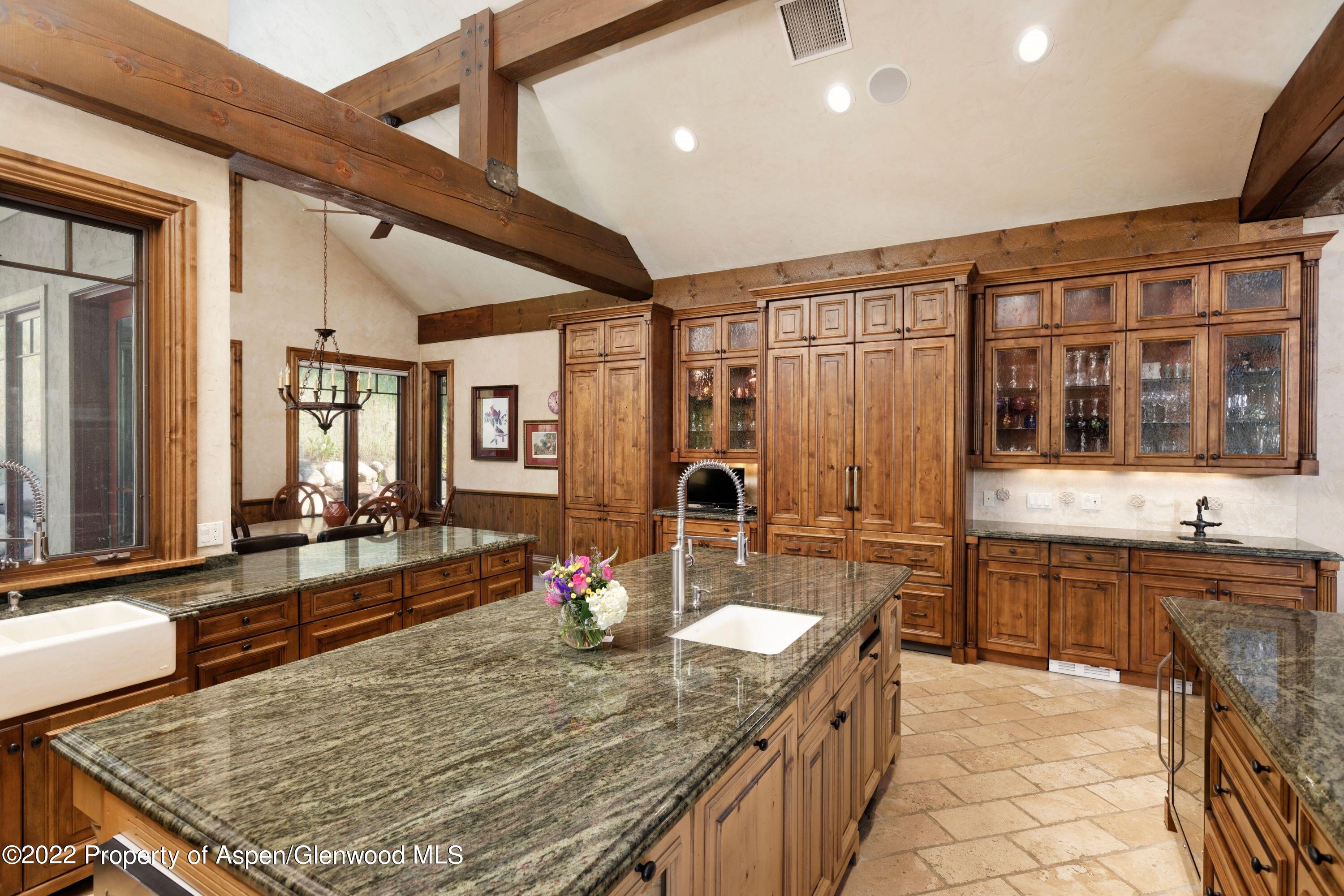 64 Spruce Ridge Lane Snowmass Village, CO 81615 - Photo 8 of 37 a kitchen with sink stove and dining table