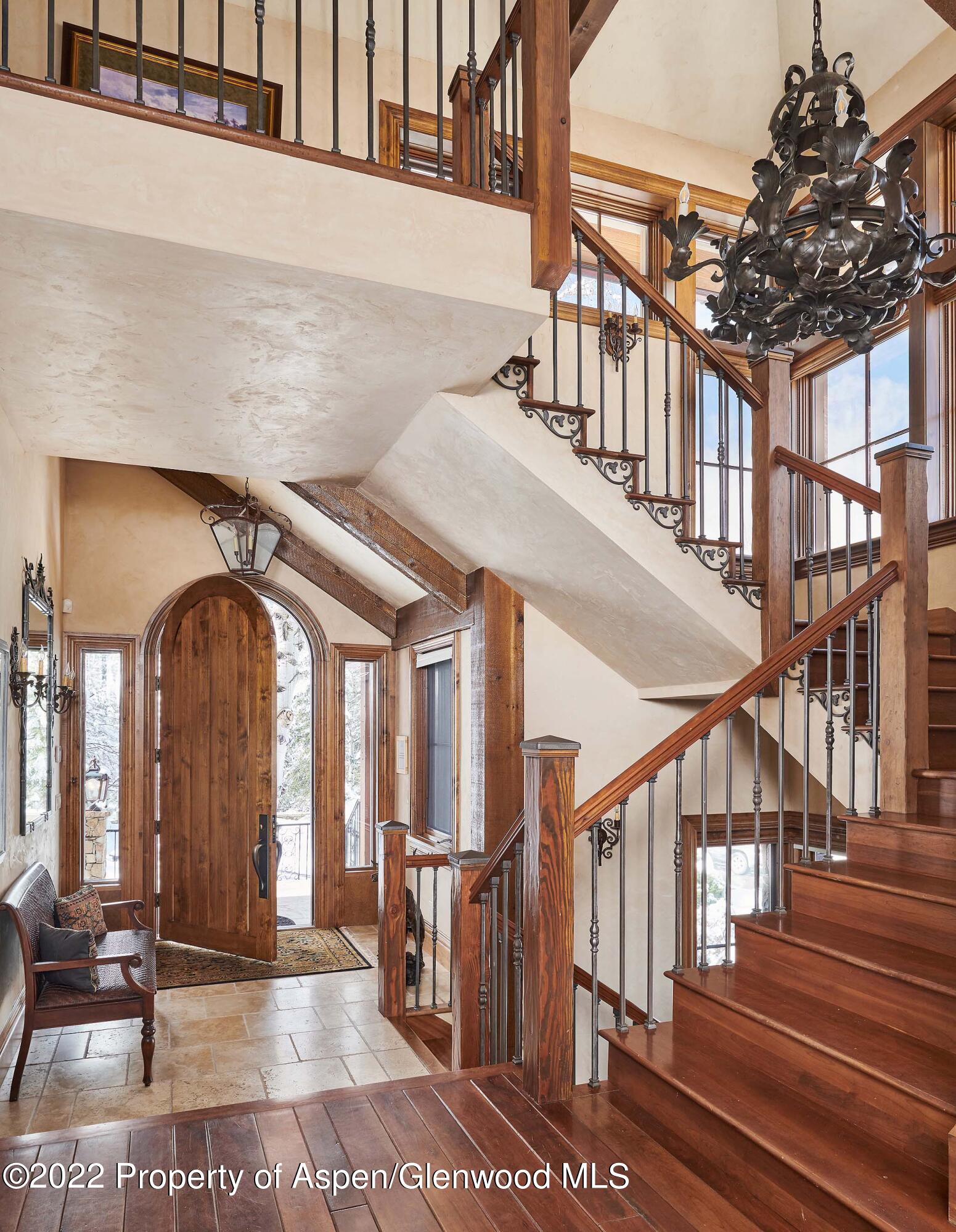 64 Spruce Ridge Lane Snowmass Village, CO 81615 - Photo 9 of 37 a view of staircase with lots of frames on wall and a potted plant