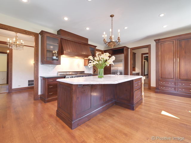 106 East 8th Street Hinsdale, IL 60521 - Photo 5 of 24 a kitchen with kitchen island granite countertop wooden cabinets and a granite counter tops