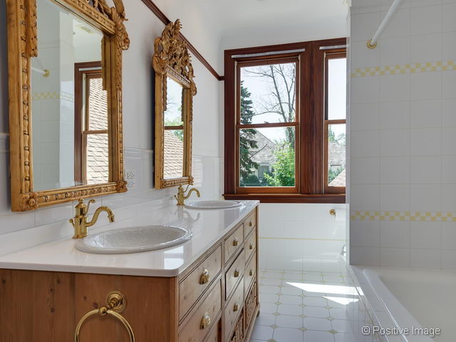 106 East 8th Street Hinsdale, IL 60521 - Photo 10 of 24 a bathroom with a granite countertop sink and a large mirror
