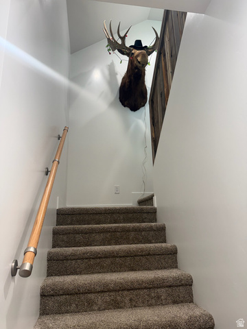 3550 North River Ln Road East Panguitch, UT 84759 - Photo 19 of 25 Carpeted staircase with light wood-finish handrail and brushed metal brackets
