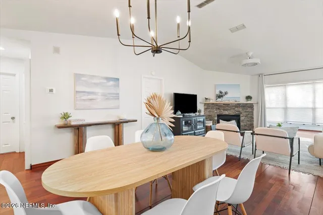 a dining room with furniture a window and wooden floor