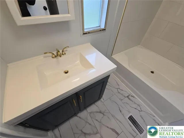 a bathroom with a sink and a bathtub