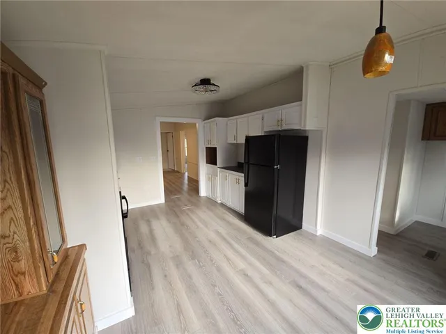 a view of a kitchen from a hallway