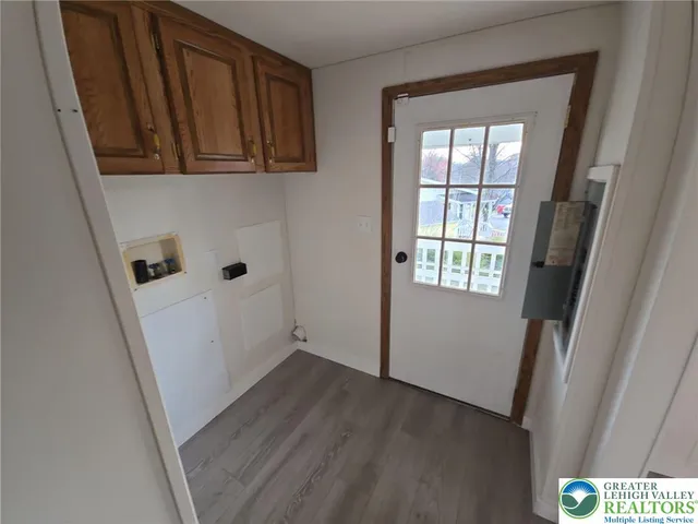 a view of an entryway with wooden floor