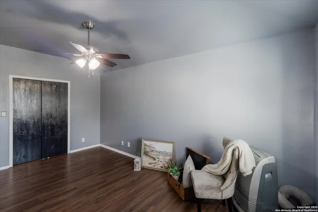 a view of a room with wooden floor lounge chair and windows