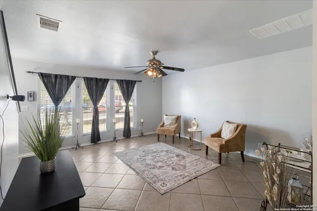 a living room with furniture a chandelier and a rug