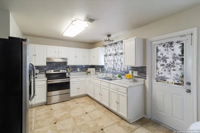 a kitchen with granite countertop cabinets and steel stainless steel appliances