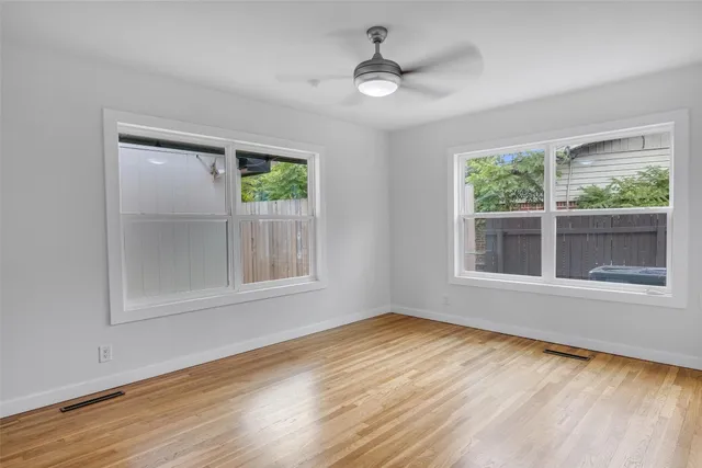 wooden floor in an empty room with a window