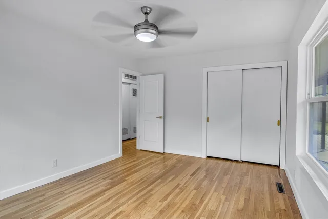 a front view of a house with a yard and potted plants