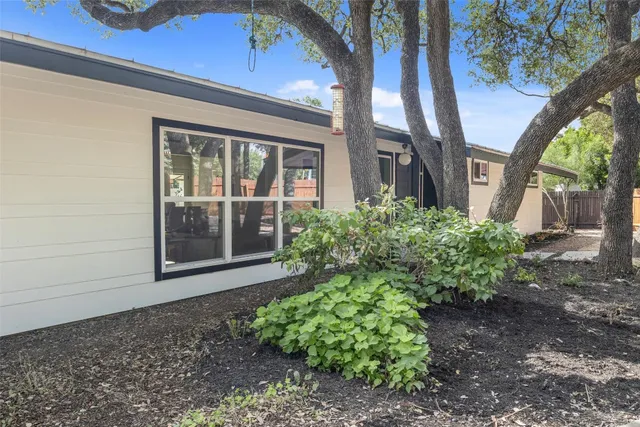 an aerial view of city lake and trees