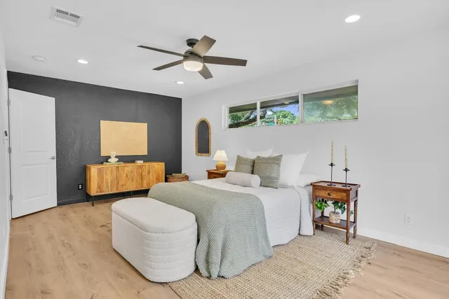 a bedroom with bed and window