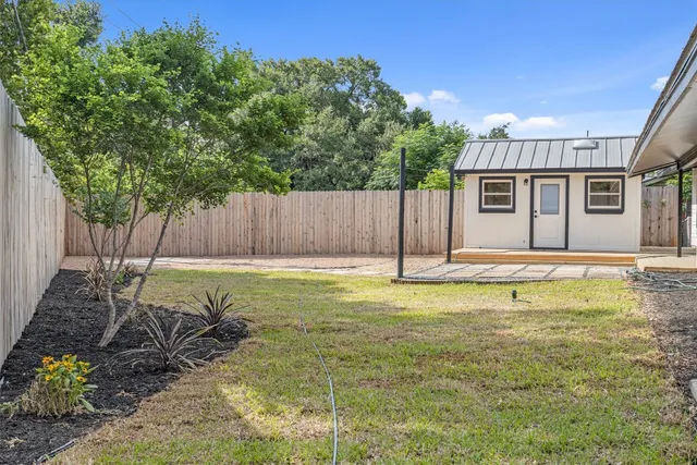 a swimming pool with outdoor seating and yard