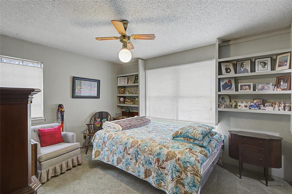 243 County Road 3851 Poolville, TX 76487 - Photo 19 of 34 a bedroom with a bed and a chandelier