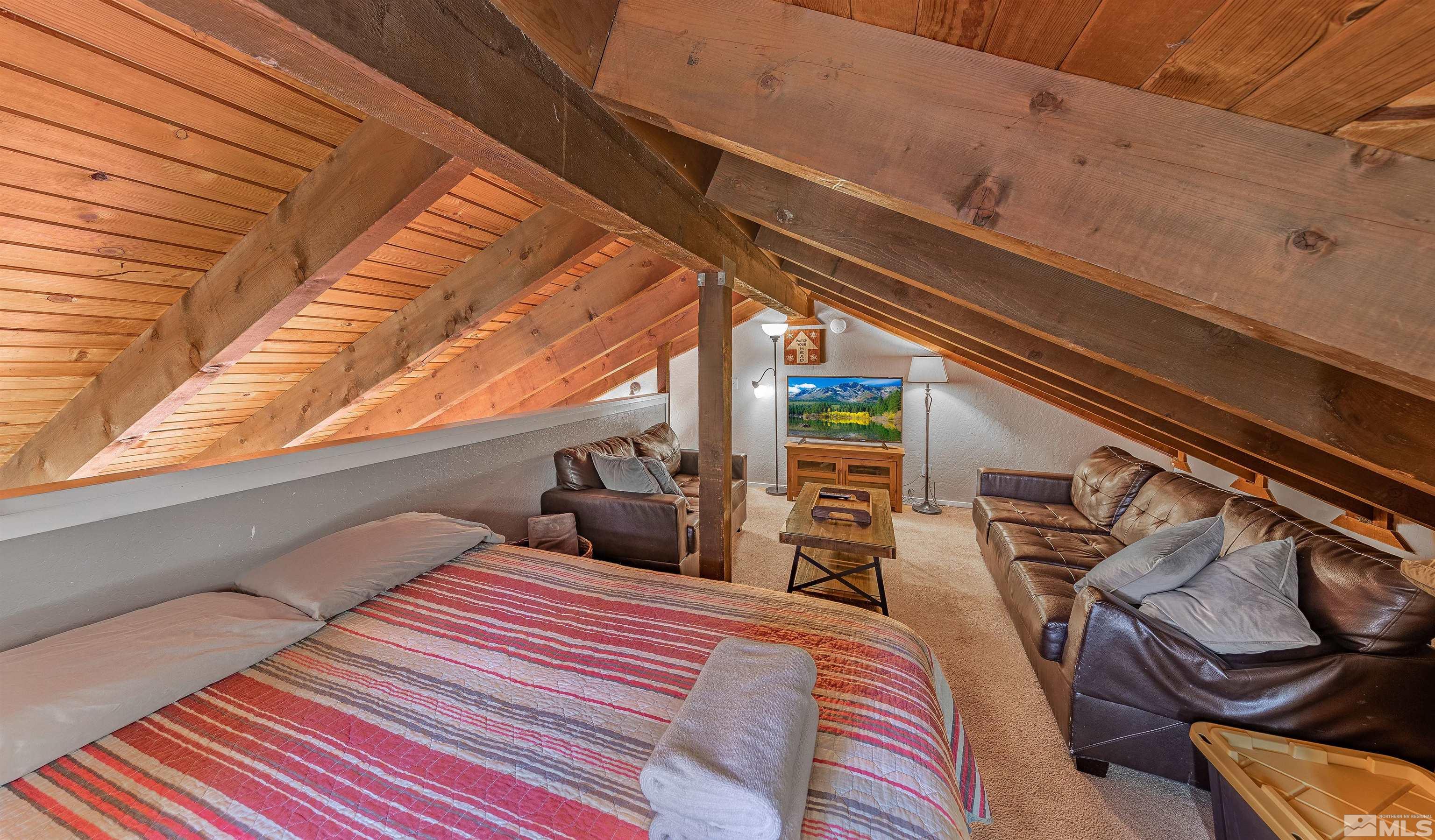 181 Tramway Drive, Unit B Stateline, NV 89449 - Photo 12 of 27 a bedroom with a bed and wooden floor