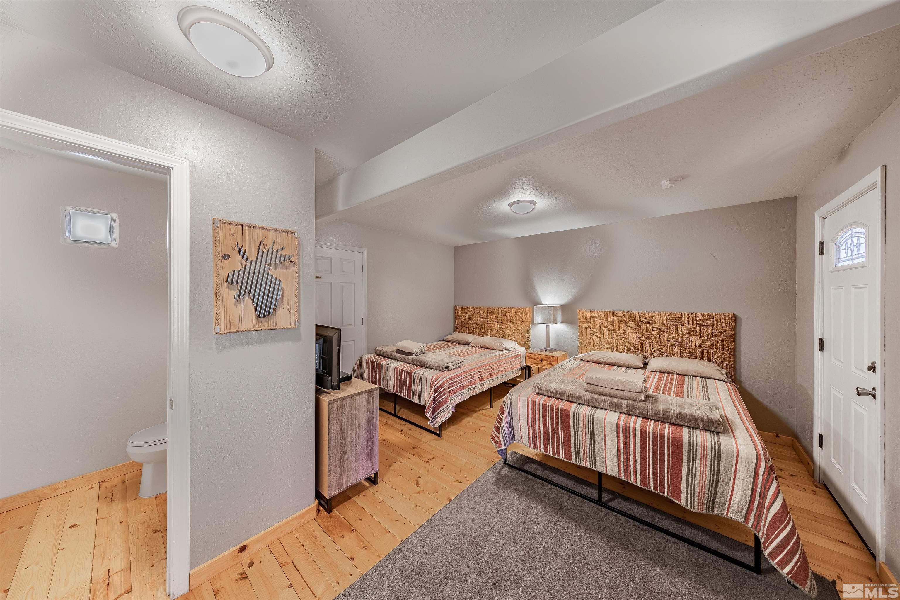 181 Tramway Drive, Unit B Stateline, NV 89449 - Photo 13 of 27 a bedroom with two beds and painting on the wall