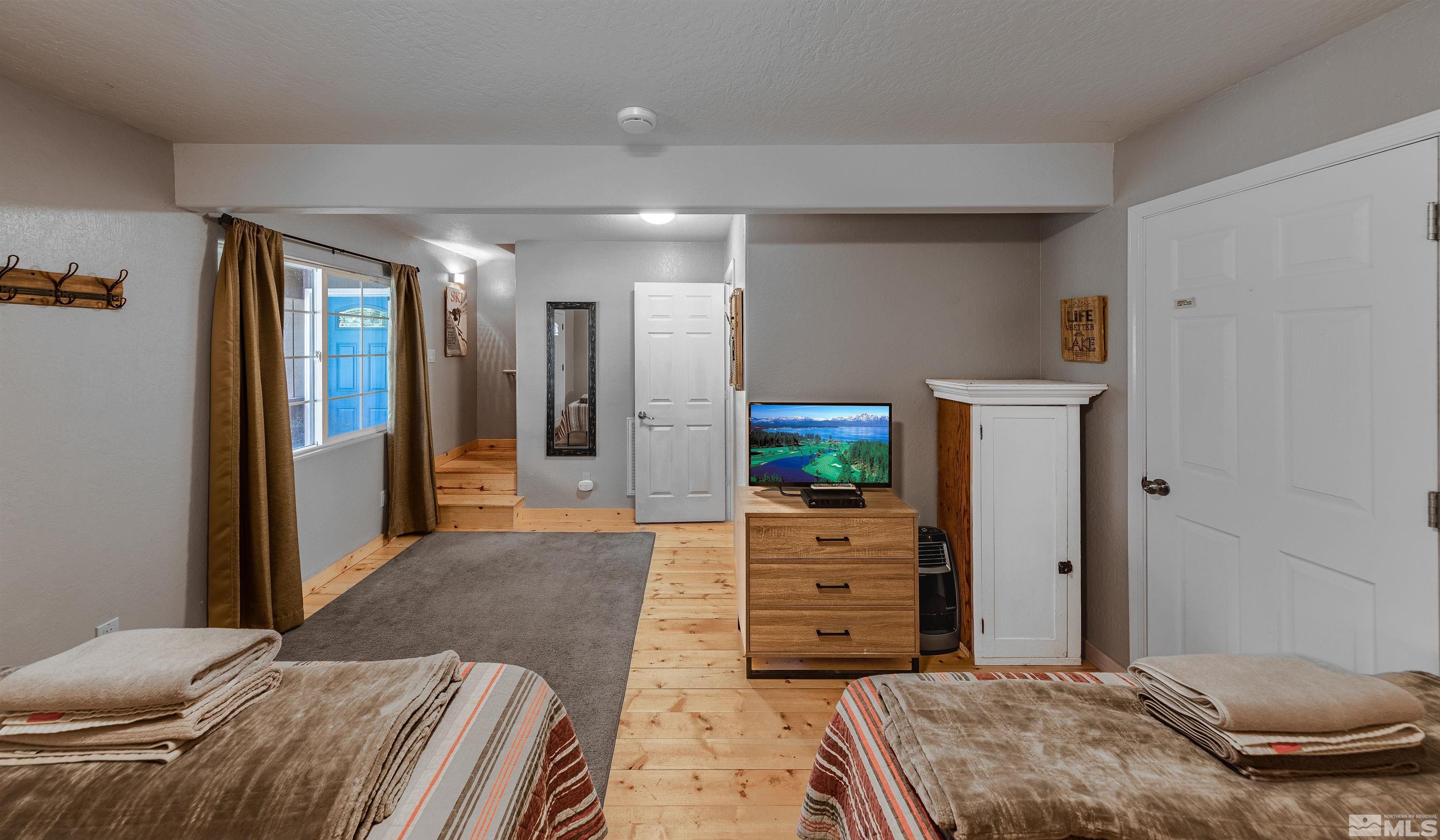 181 Tramway Drive, Unit B Stateline, NV 89449 - Photo 14 of 27 a bedroom with a bed and furniture