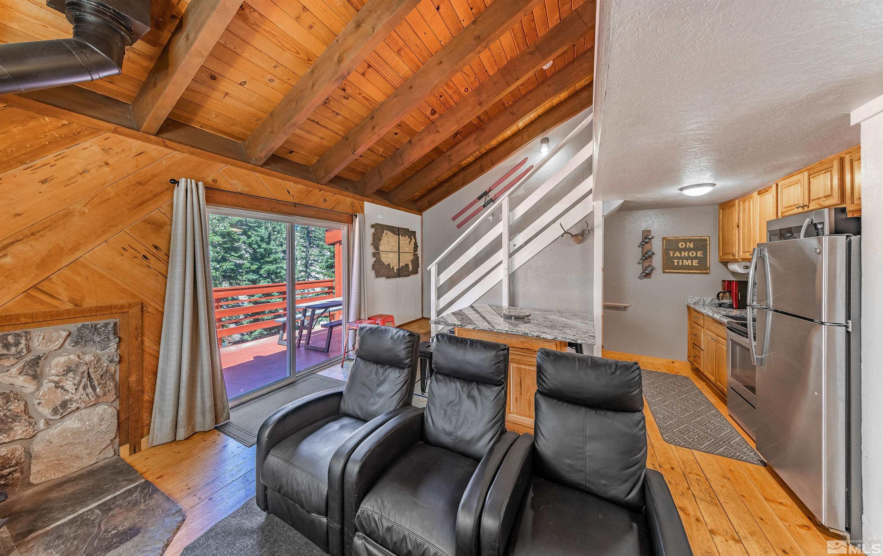 181 Tramway Drive, Unit B Stateline, NV 89449 - Photo 3 of 27 a living room with furniture and a floor to ceiling window