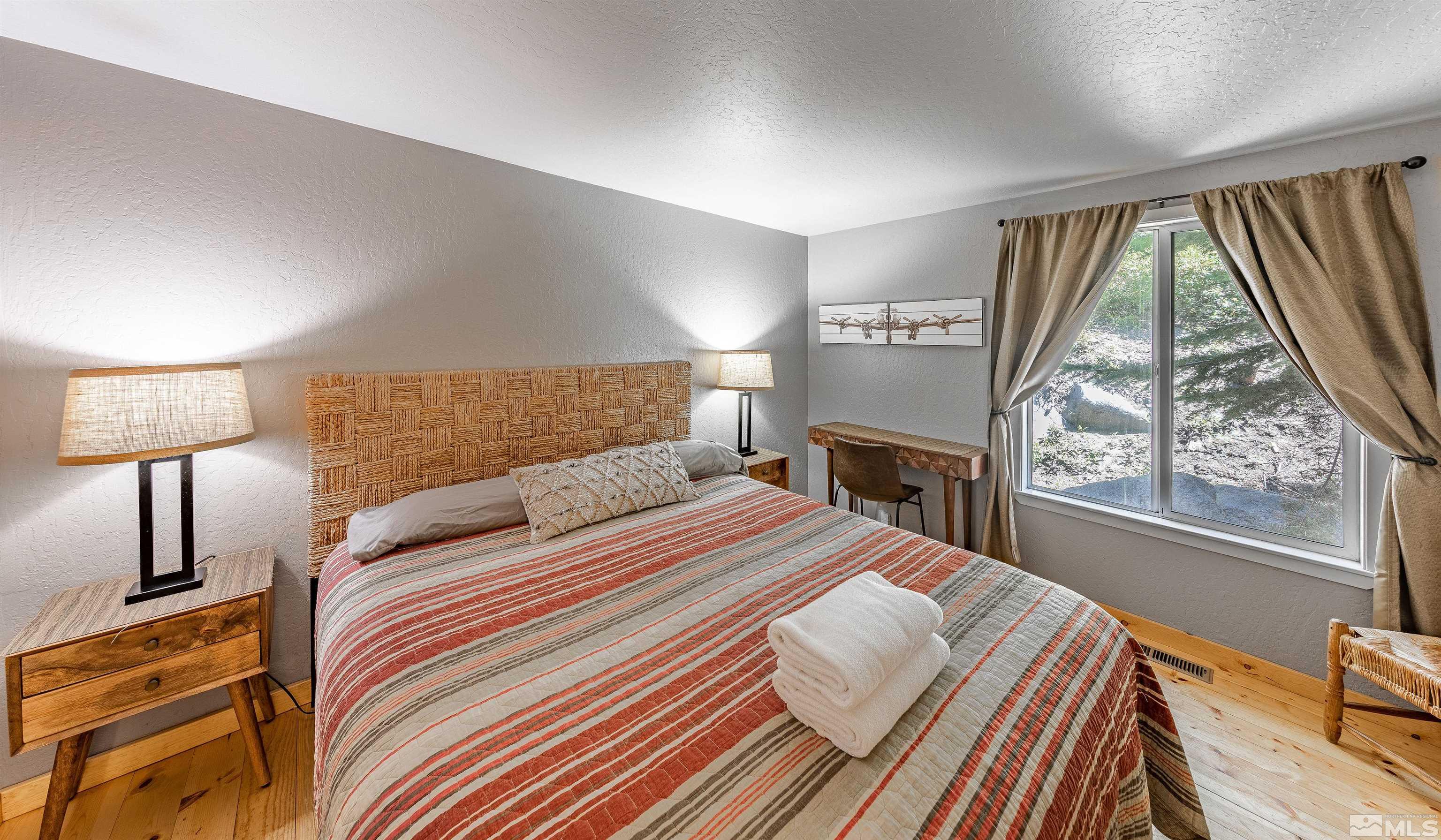181 Tramway Drive, Unit B Stateline, NV 89449 - Photo 8 of 27 a bedroom with a large bed and a window