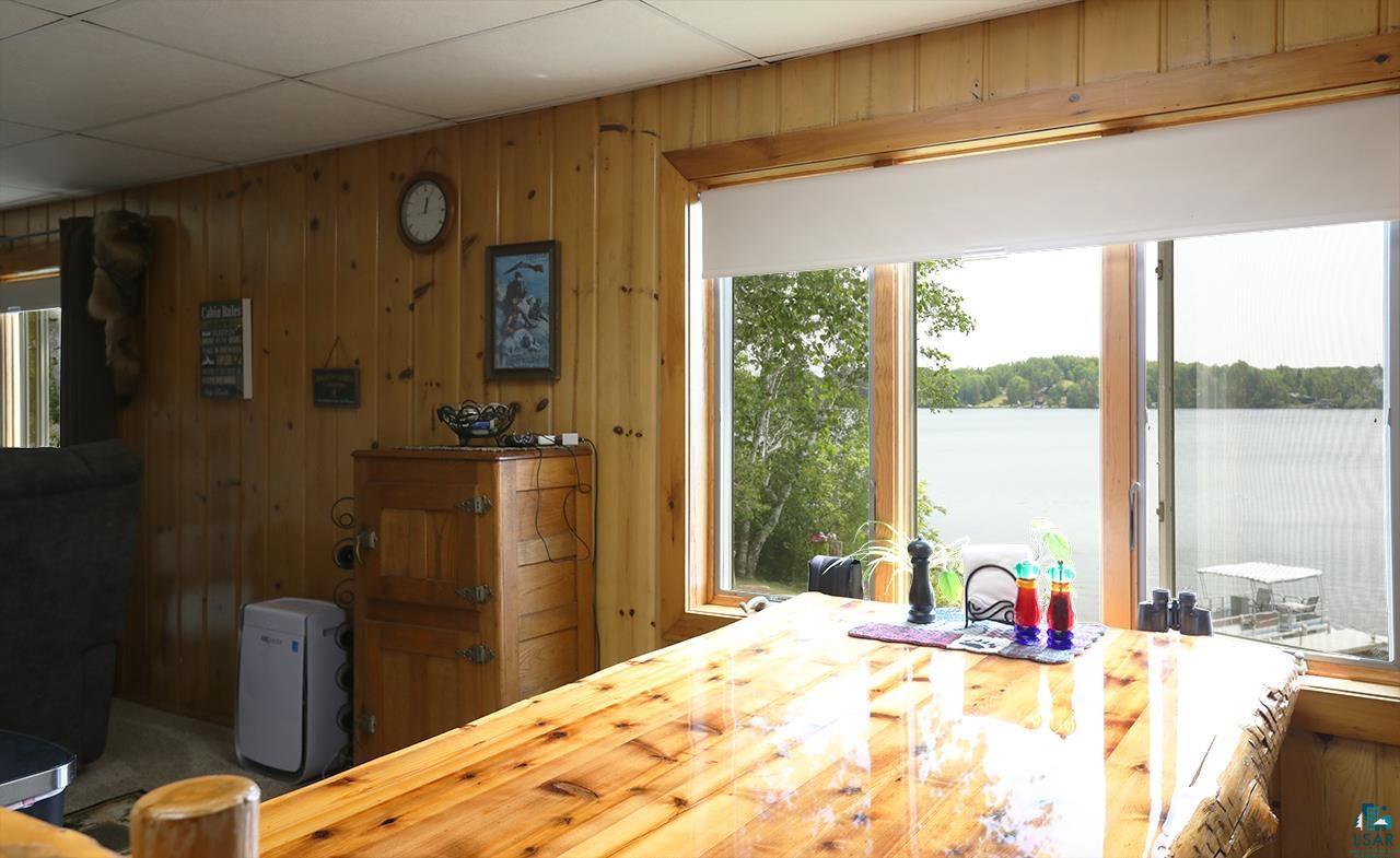 1198 West Mink Road Cotton, MN 55724 - Photo 8 of 23 Dining area with a water view and wooden walls