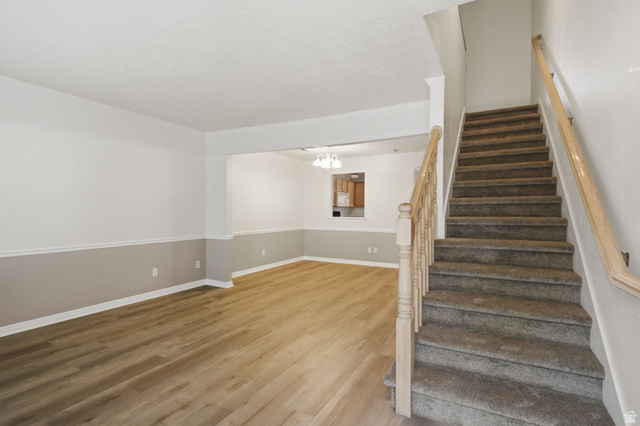 794 East 950 S Street Provo, UT 84606 - Photo 13 of 28 Living area featuring wood-finish flooring, two-tone wall paint, and white baseboards