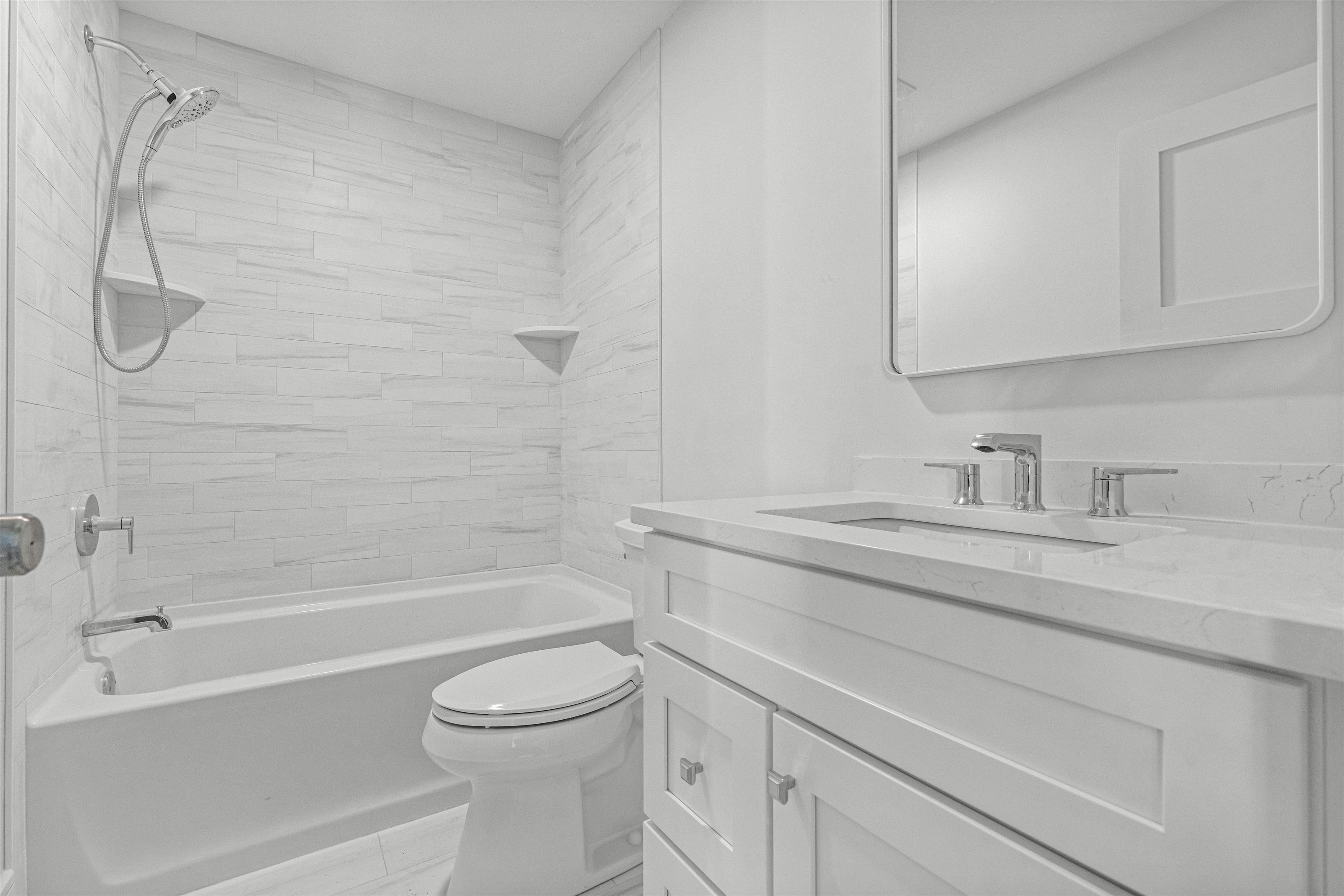 1819 Dune Drive Avalon, NJ 08202 - Photo 16 of 49 a bathroom with a granite countertop sink a toilet and a bathtub