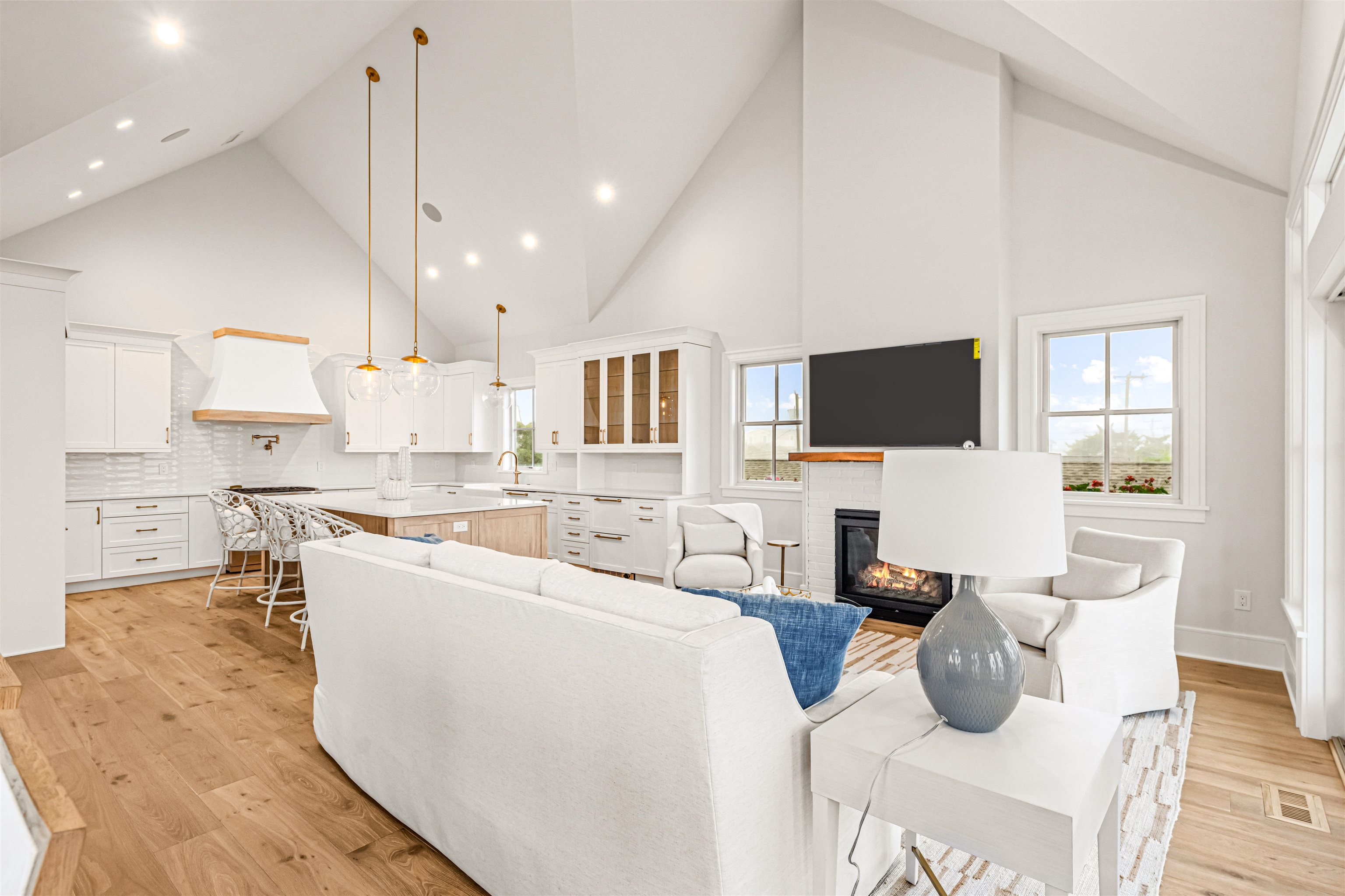 1819 Dune Drive Avalon, NJ 08202 - Photo 24 of 49 a living room with stainless steel appliances furniture a flat screen tv and a chandelier