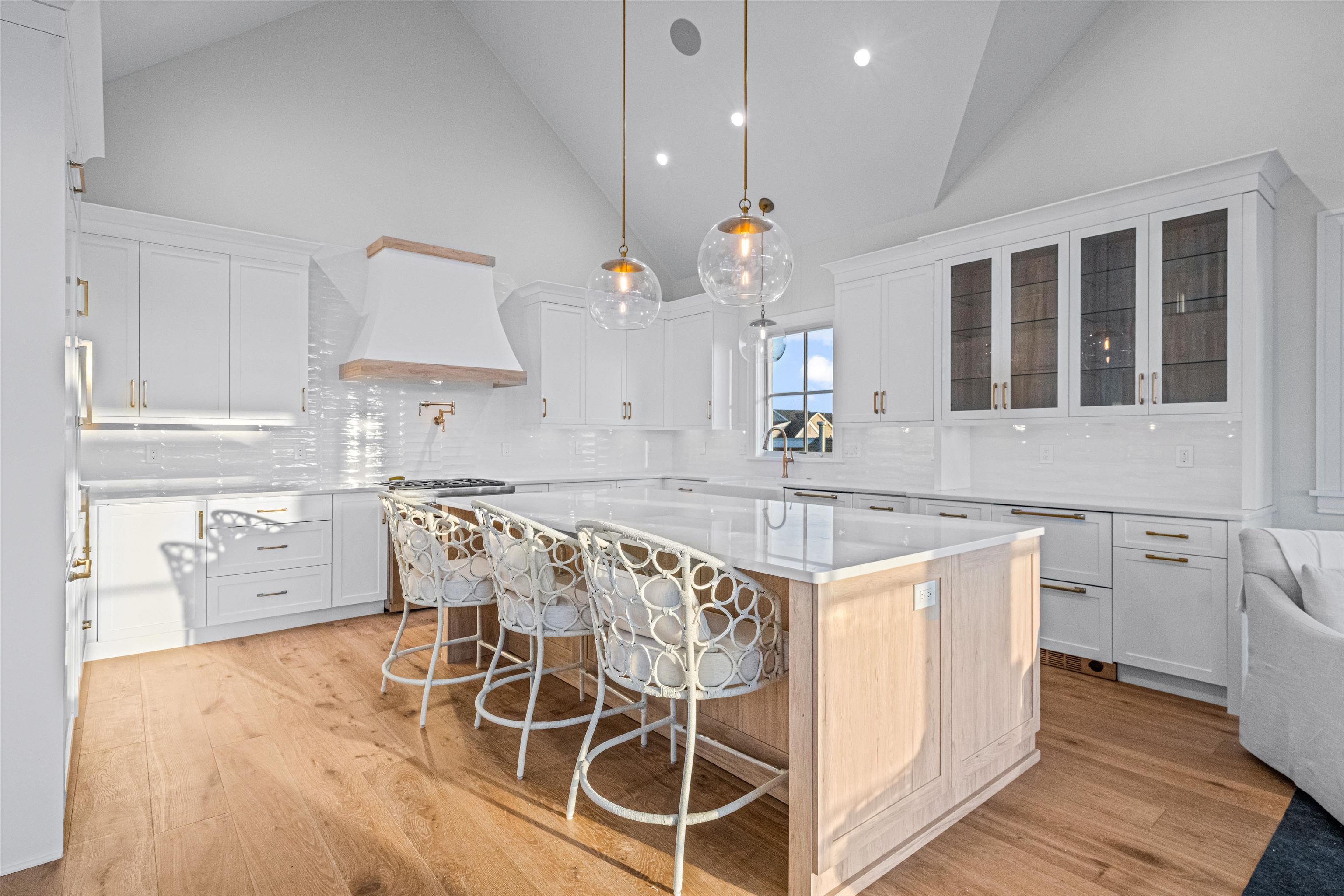 1819 Dune Drive Avalon, NJ 08202 - Photo 28 of 49 a kitchen with granite countertop a stove a sink and white cabinets with wooden floors