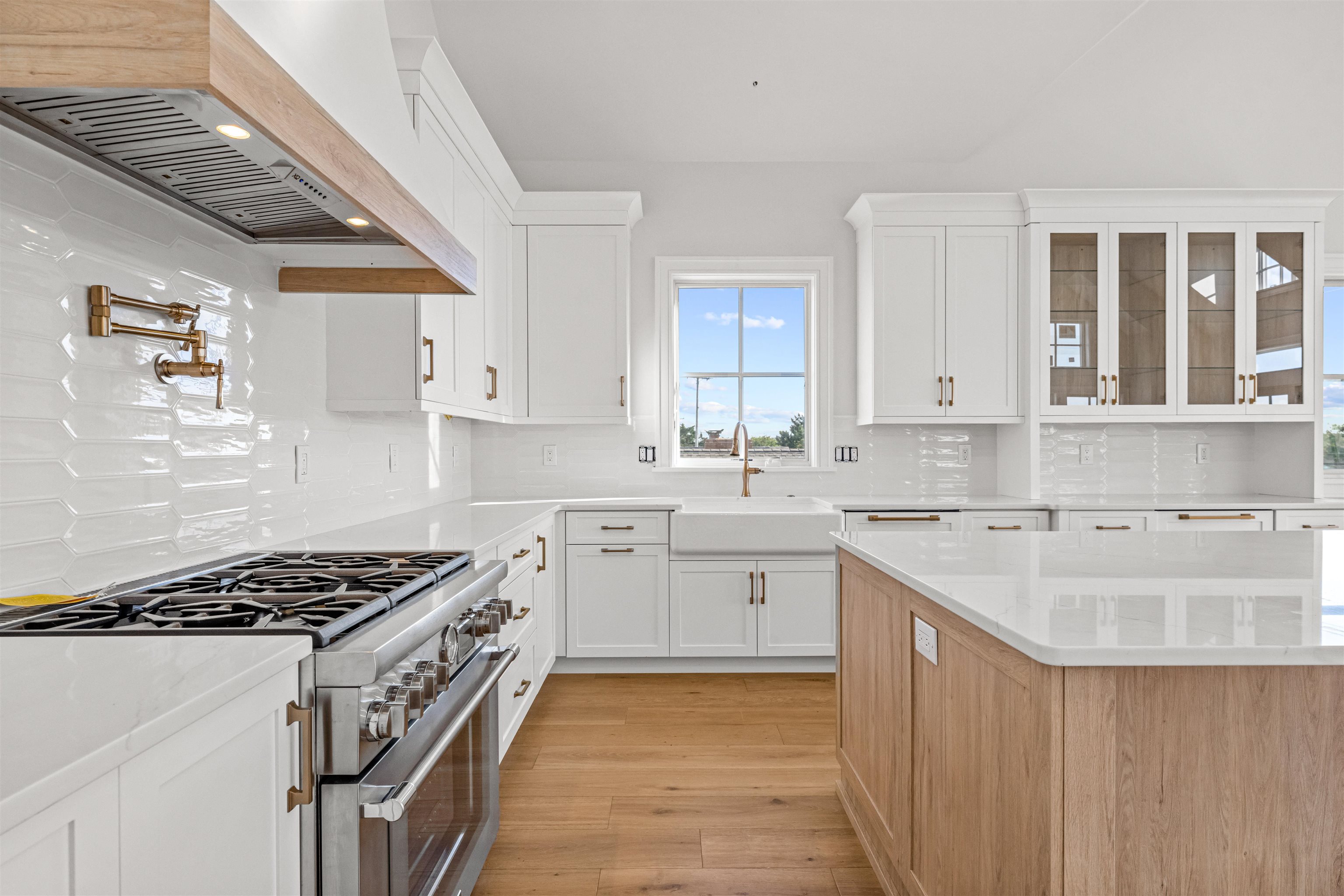 1819 Dune Drive Avalon, NJ 08202 - Photo 30 of 49 a kitchen with kitchen island granite countertop a sink stove and cabinets