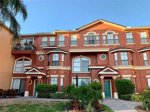 a front view of a residential apartment building with a yard