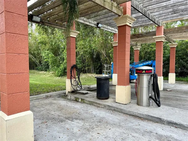a view of a patio with a table chairs and a yard