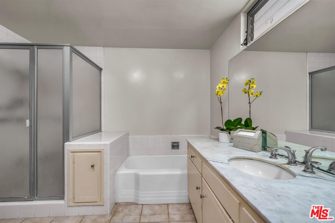 4320 Monteith Drive View Park, CA 90043 - Photo 11 of 17 a bathroom with a granite countertop bathtub sink vanity mirror and toilet