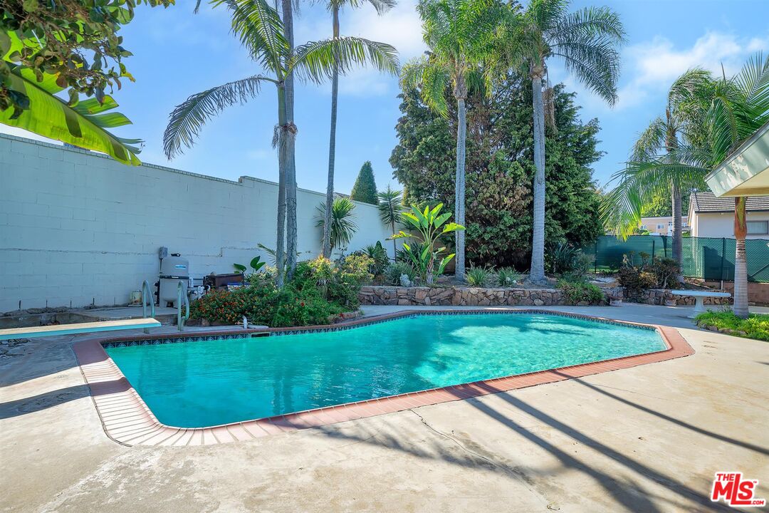 4320 Monteith Drive View Park, CA 90043 - Photo 15 of 17 a view of a swimming pool with a garden and palm trees